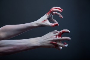Zombie stretching bloody hands